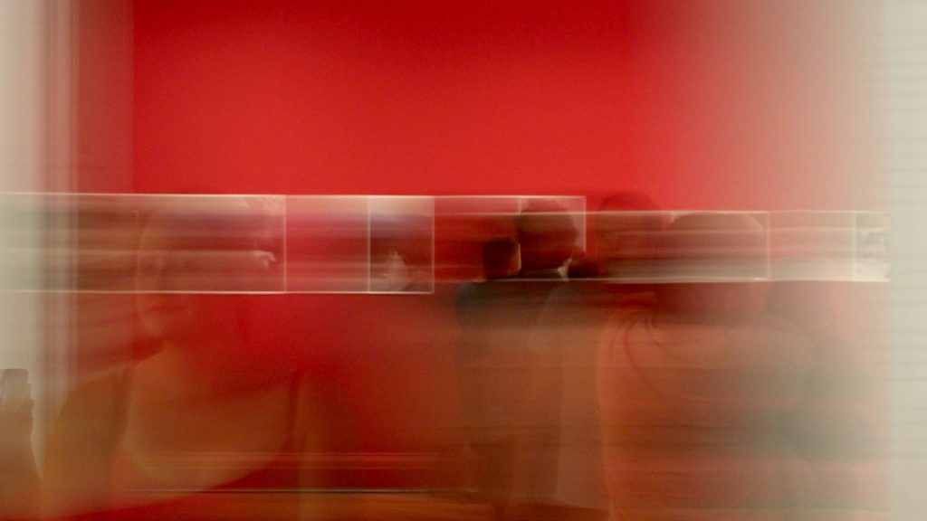 Abstract red motion blur artwork with horizontal light streaks